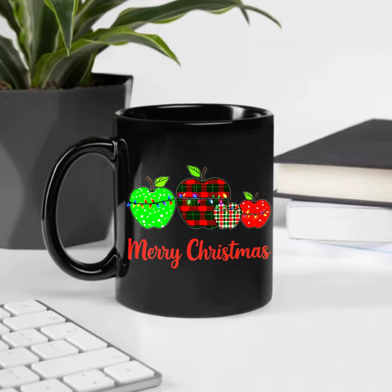 Tasse à café noire avec motif pomme de Noël et texte "Joyeux Noël"